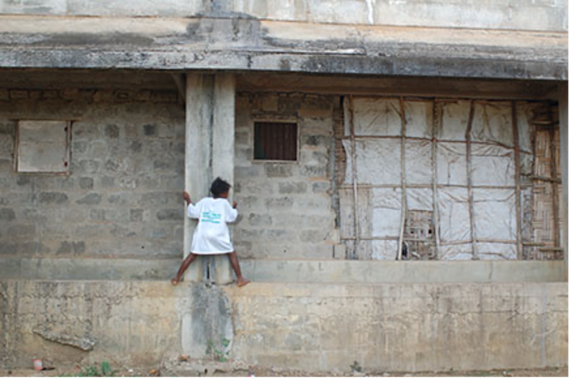 A girl plays inside the unfinished Liberian Broadcasting System headquarters.