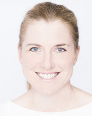 A close-up image of Margaret O'Mara smiling with a white background.