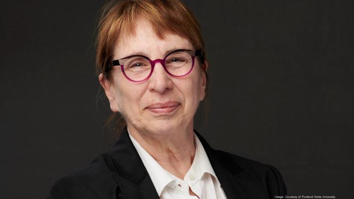 Susan Jeffords looks into the camera while wearing a suit and glasses.