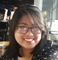 A portrait of Anna Nguyen wearing glasses.