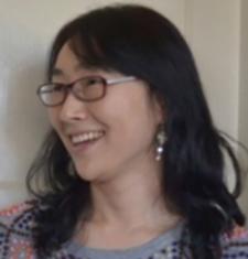 Heekyoung Cho looks to the left while wearing glasses.