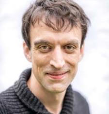 Portrait of Robert Anderson wearing a dark grey sweater.