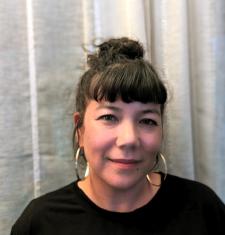 Portrait photo of Taiko against a white curtain background