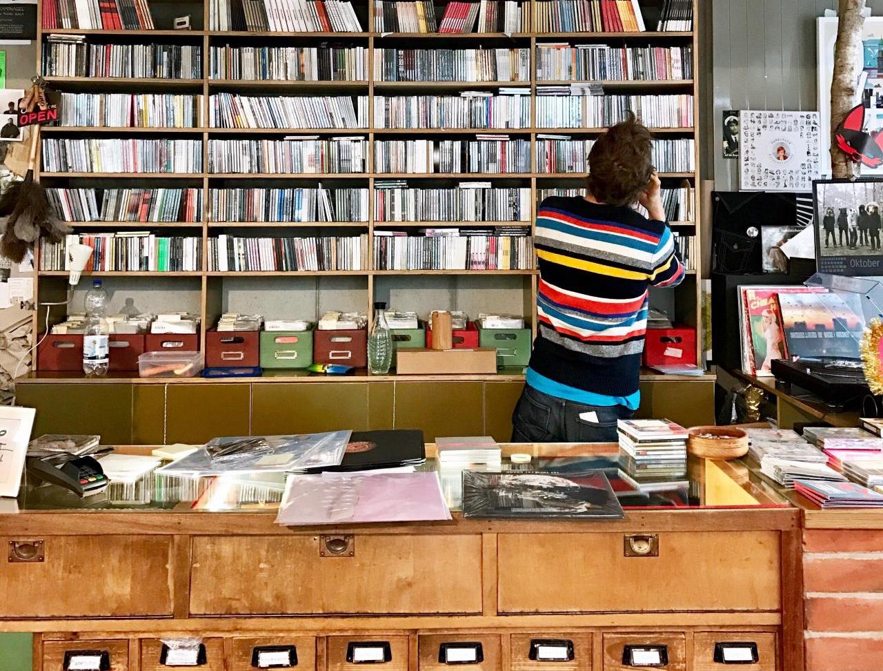 scholar in a library looking through book and media stacks