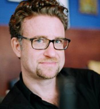 Christian Novetzke wears a black shirt and glasses.