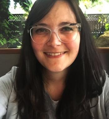 Portrait of Maryam Griffin wearing glasses.
