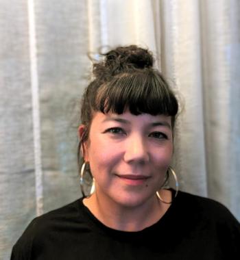 Portrait photo of Taiko against a white curtain background