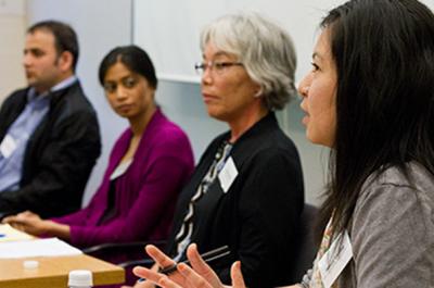 Scholars speaking at a conference