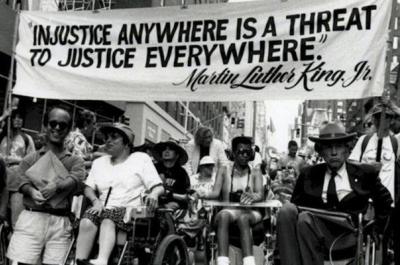 Image of protestors in Washington, D.C. advocating for disability rights with signs.