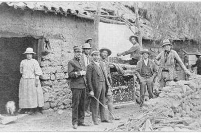 Old black and white photograph from the Yale Peruvian Expedition of people standing in front of a building