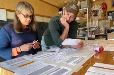 Project leads Lynn and Danny working together at a table