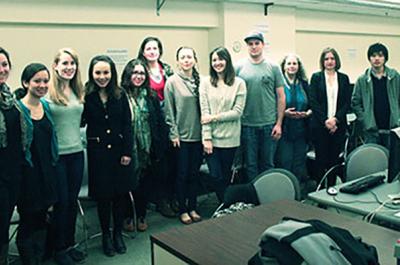 Members of the Svoboda Diaries Newbook Project stand in a classroom. 