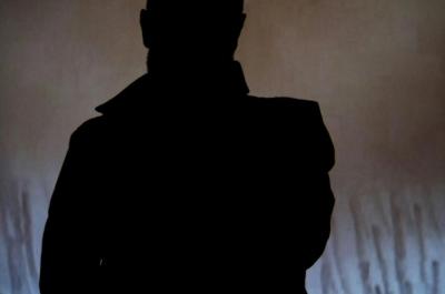 Silhouette of person in front of screen