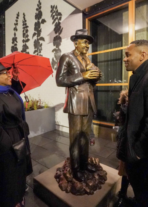 Vivian Phillips and artist Barry Johnson smile after Johnson’s sculpture of Dr. James W. Washington Jr. was unveiled at Midtown Center. (Photo: Susan Fried)