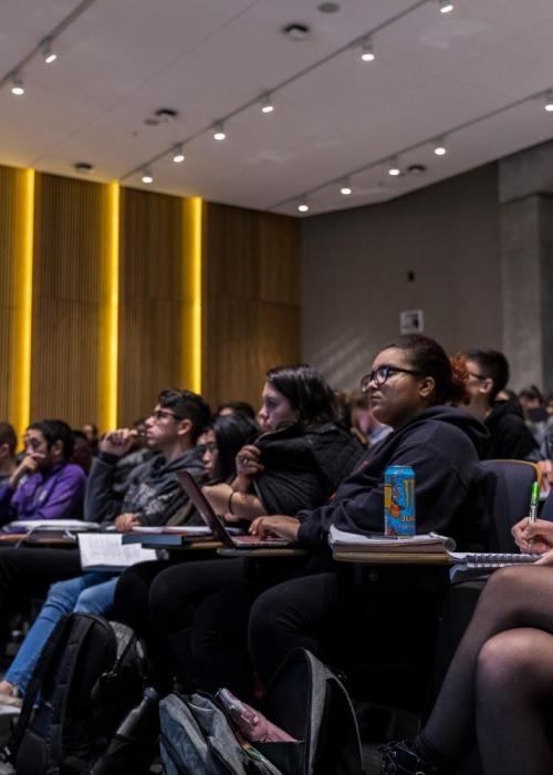 People sit in an auditorium.