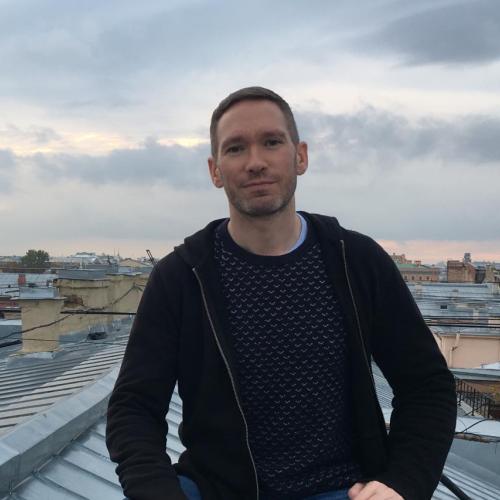 Brendan McElmeel stands on a rooftop wearing a dark shirt.