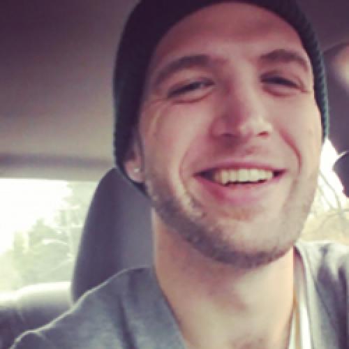 Bradley Horst sits in the driver seat of a car while wearing a beanie.