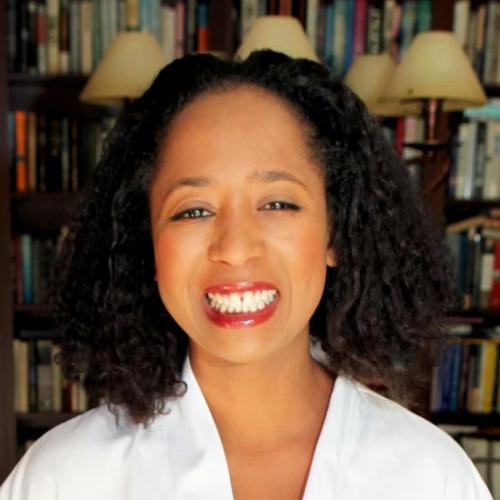 A portrait of Jasmine Mahmoud standing in front of a bookcase.