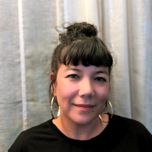 Portrait photo of Taiko against a white curtain background