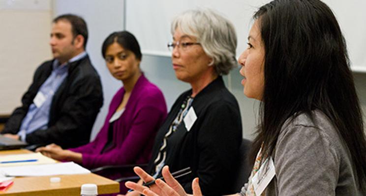 Scholars speaking at a conference