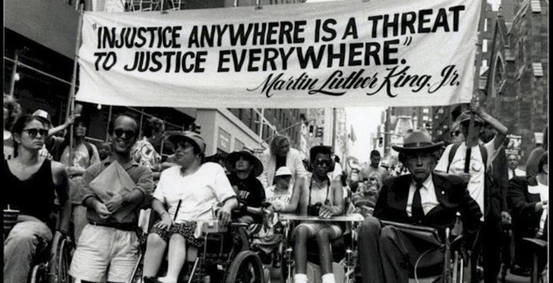 Image of protestors in Washington, D.C. advocating for disability rights with signs.