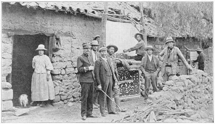 Old black and white photograph from the Yale Peruvian Expedition of people standing in front of a building