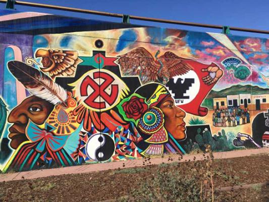 "Quetzalocoatl" is the first collective mural painted in Chicano Park, San Diego, in 1973. The artists, Guillermo Aranda, Salvador Barrajas, Jose Cervantes, Sammy Llamas, Bebe Llamas, Victor Ochoa, Ernest Paul, Arturo Roman, Guillermo Rosete, Mario Torero, and Salvador Torres, unify mythical images grounded in Indigenous stories of the southern California border region. Photo courtesy Lydia Heberling