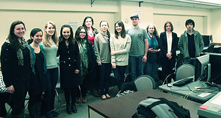 Members of the Svoboda Diaries Newbook Project stand in a classroom. 