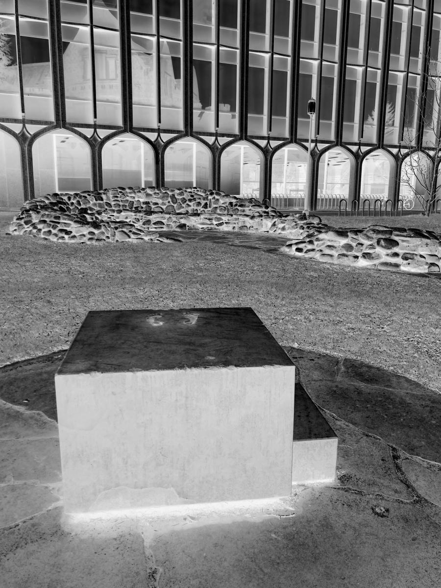 An inverted black and white image of "Blocked Out," a monument on the University of Washington Seattle campus.