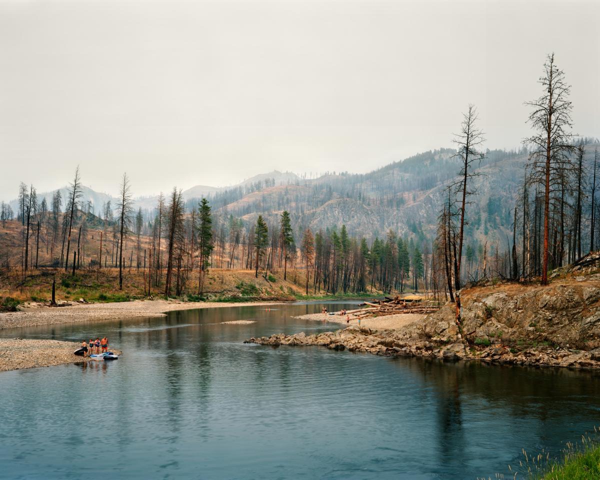 Pepole recreating in burnt smoky landscape
