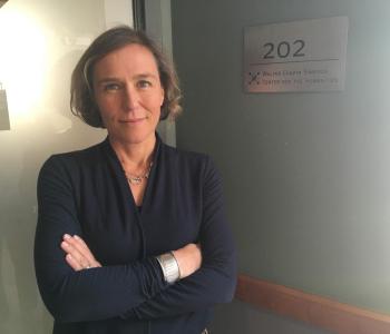 Professor Amelia Glaser standing outside the Simpson Center seminar room