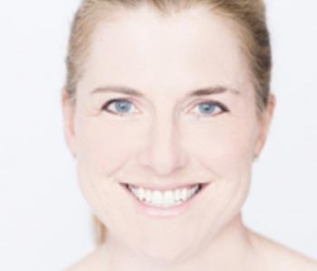 A close-up image of Margaret O'Mara smiling with a white background.