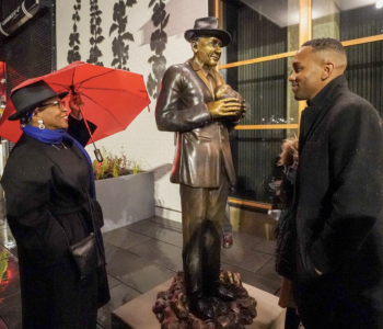 Vivian Phillips and artist Barry Johnson smile after Johnson’s sculpture of Dr. James W. Washington Jr. was unveiled at Midtown Center. (Photo: Susan Fried)