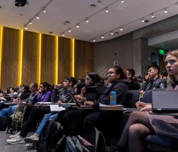 People sit in an auditorium.