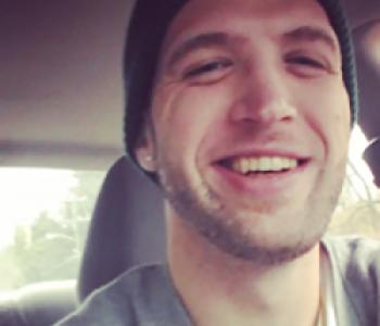 Bradley Horst sits in the driver seat of a car while wearing a beanie.