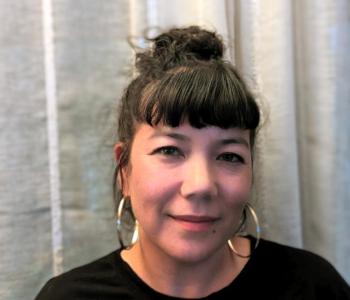 Portrait photo of Taiko against a white curtain background