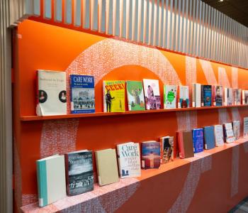 Books arranged on shelves for an exhibit.