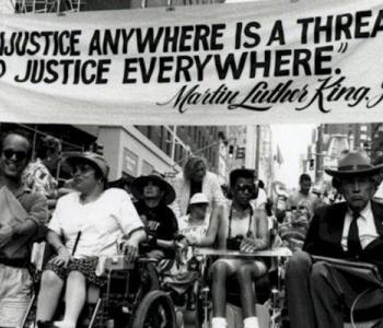 Image of protestors in Washington, D.C. advocating for disability rights with signs.