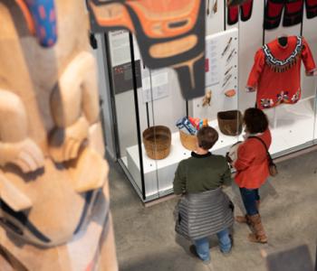 Two people look at a museum exhibit.