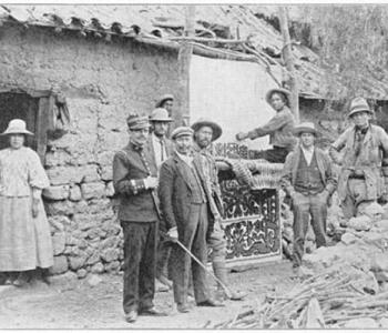 Old black and white photograph from the Yale Peruvian Expedition of people standing in front of a building