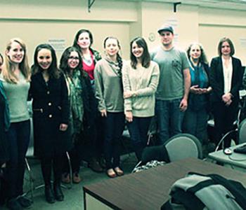 Members of the Svoboda Diaries Newbook Project stand in a classroom. 