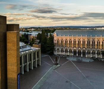 birds-eye view of the Suzallo and Allen Libraries with the brick-laid quad in the middle. It is a sunny day morning with light clouds in the sky.