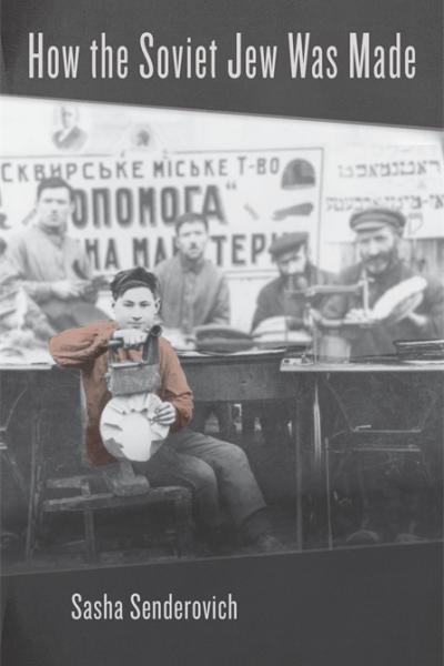 Black and white image of several men looking at the camera with a boy wearing a ping sweater vest in the foreground.